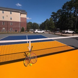 a pickleball court with tennis rackets