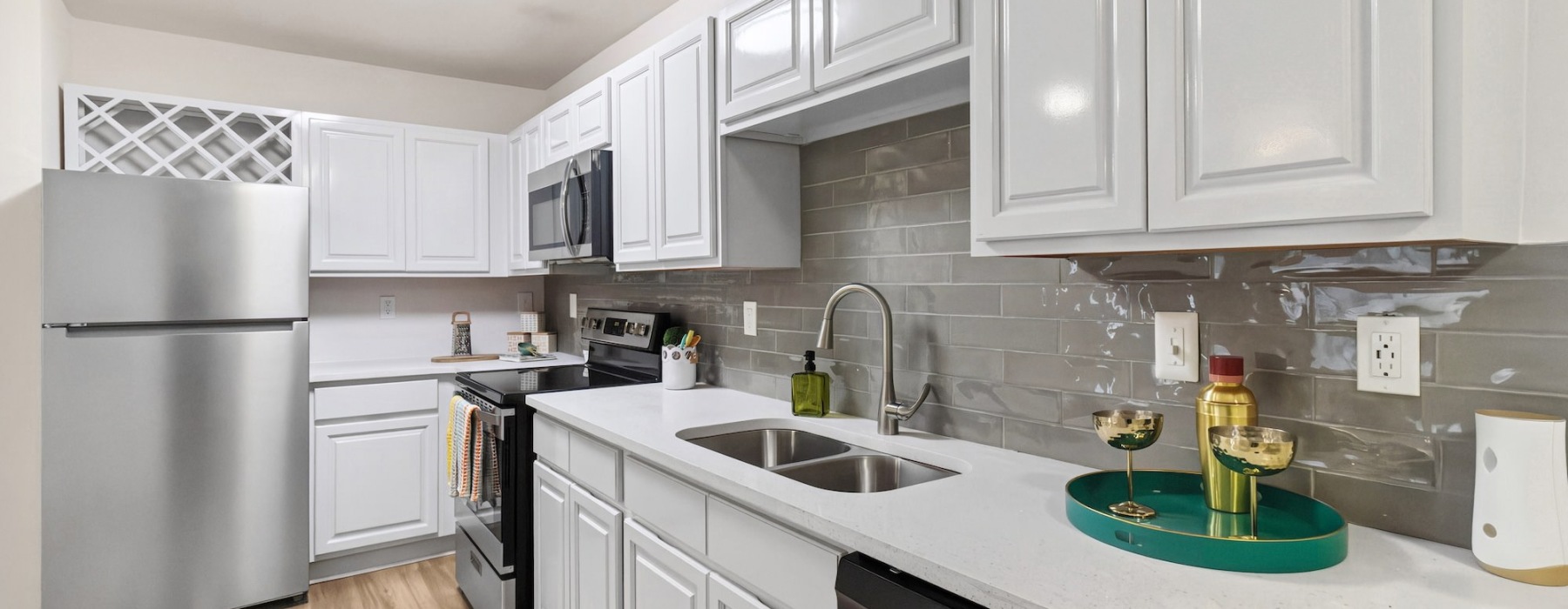 kitchen with stainless steel appliances and white cupboards