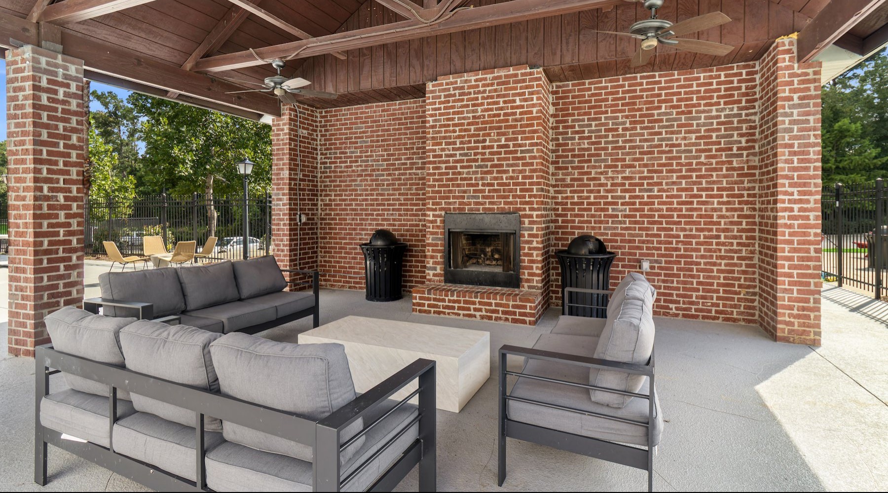 outdoor covered patio with seating and a fireplace