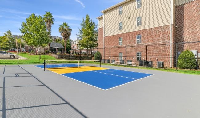 a pickle ball court in front of a building