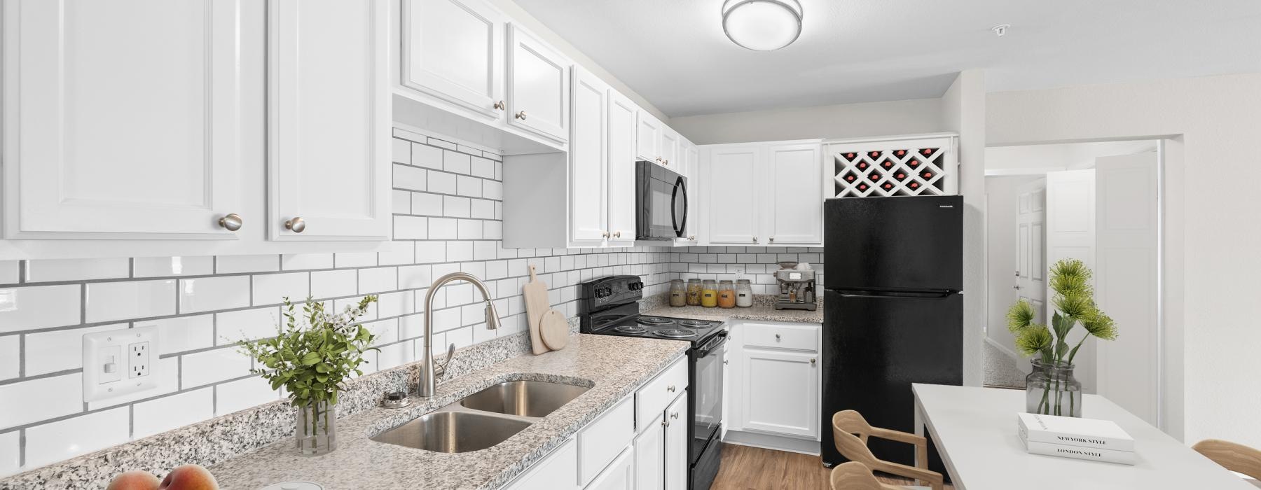 a kitchen with white cabinets