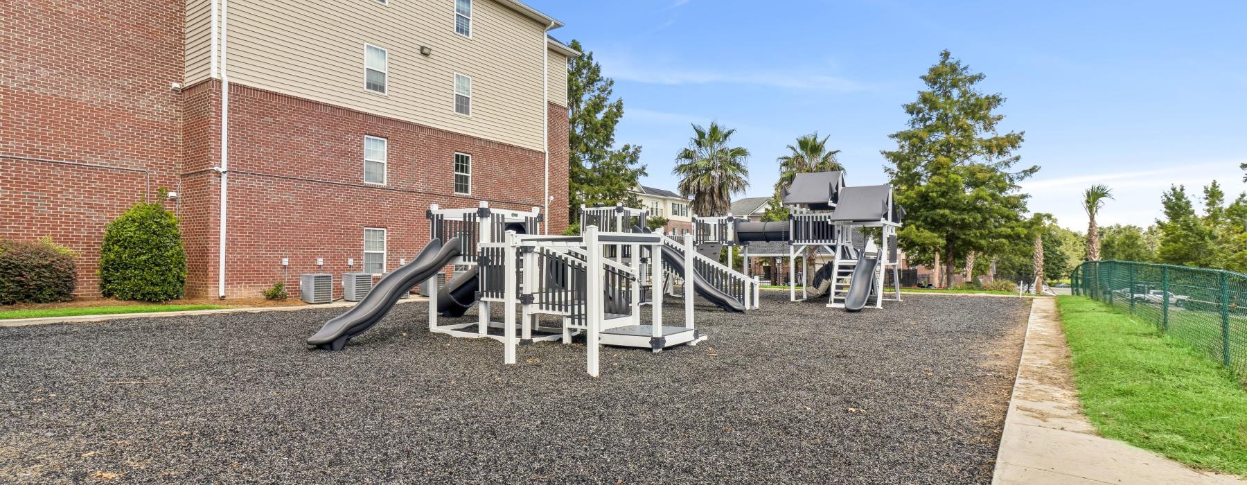 a playground in front of a brick building