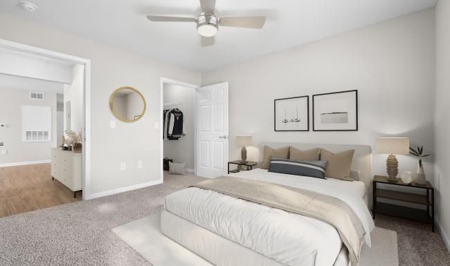 a bedroom with a bed and a fan